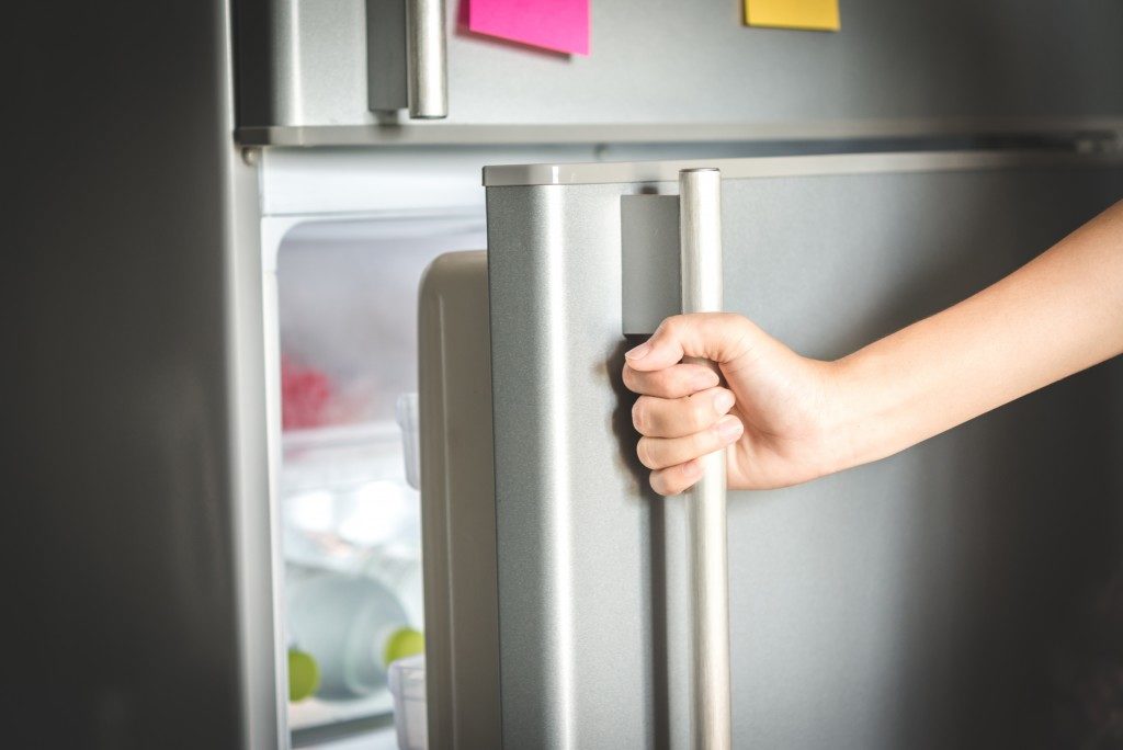 closeup of refrigerator being opened