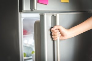 closeup of refrigerator being opened