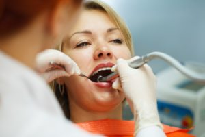 Female patient having her teeth examined