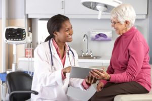 Doctor discussing records with female patient