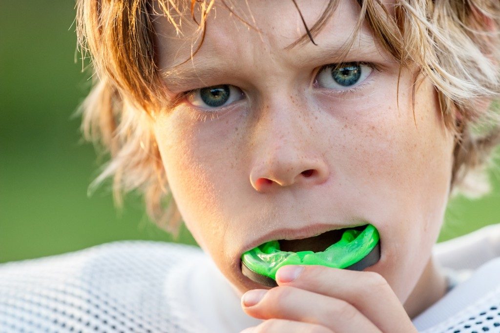 Kid wearing mouthguard