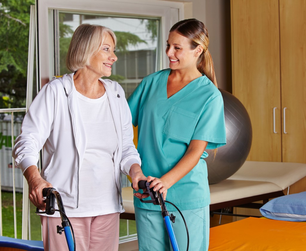 Nurse assisting elderly woman