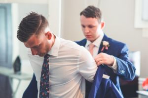 a groom getting dressed
